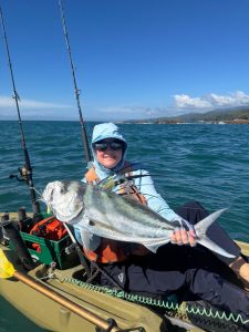 woman kayaker catching roosterfish on kayak at Los Buzos