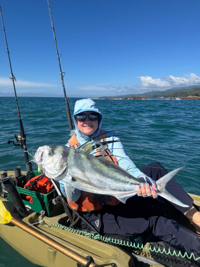 woman kayaker catching roosterfish on kayak at Los Buzos