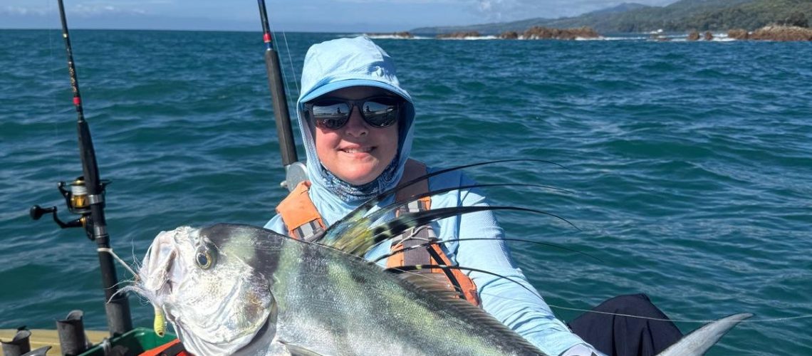 woman kayaker catching roosterfish on kayak at Los Buzos